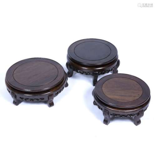 Three hardwood circular stands Chinese, 20th Century each with brass line inlay largest 34cm,
