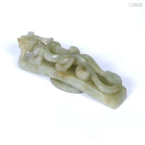 Olive green jade belt buckle Chinese, 19th Century pierced and carved with a writhing dragon 8cm x