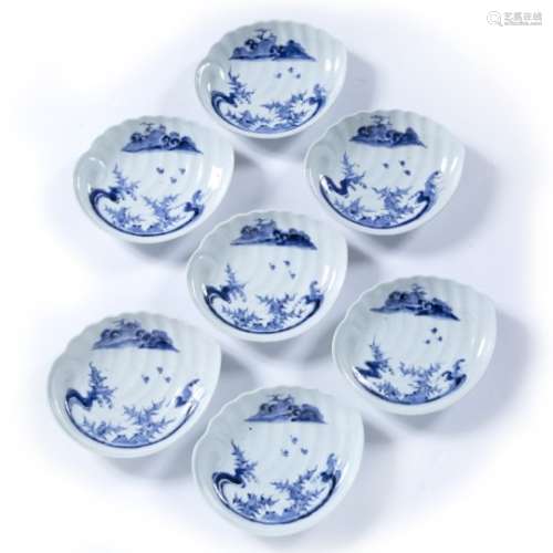Seven Hirado scallop shaped dishes, Japanese, 19th Century with blue and white decoration of seaweed
