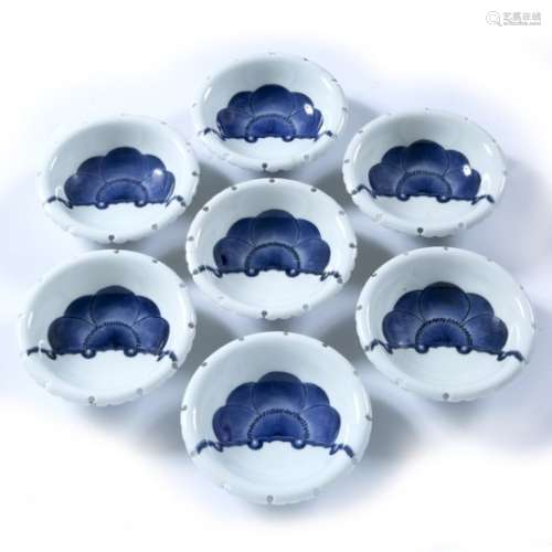 Seven Nabeshima blue and white bowls with shaped rims, with blossom motif, unmarked Japanese, 20th