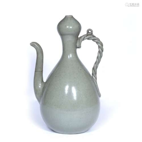 Celadon glazed ewer Japanese, 19th Century with a garlic neck top and rope twist handle 31cm high