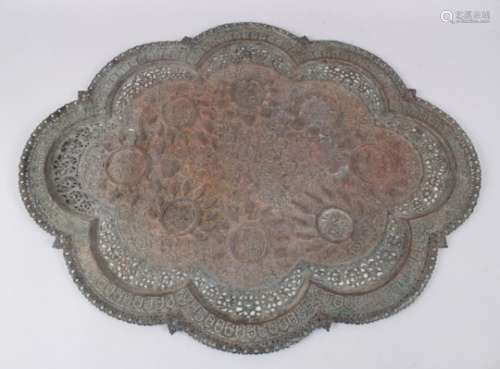 A LARGE INDIAN COPPER EMBOSSED TRAY with carved and embossed decoration, 69cm x 54cm.