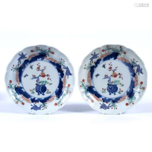 Pair of Kakiemon plates Japanese the centres decorated with a potted plant with the sides of the