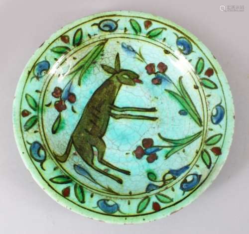 A 17TH CENTURY OTTOMAN IZNIK CERAMIC DEER DISH, the green / blue ground with floral decoration and a