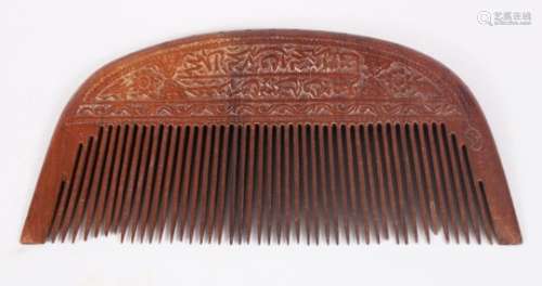 AN 18TH - 19TH CENTURY PERSIAN QAJAR CARVED WOODEN COMB, with carved scripture and foliage, 16.5cm