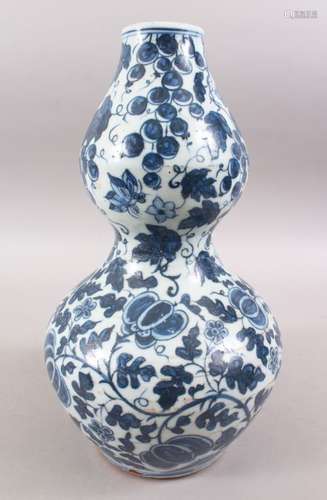 A GOOD CHINESE BLUE & WHITE DOUBLE GOURD PORCELAIN VASE, decorated with foliage and fruit, base