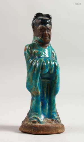 A SMALL MING POTTERY FIGURE OF A GOD with blue glaze. 5.5ins high.