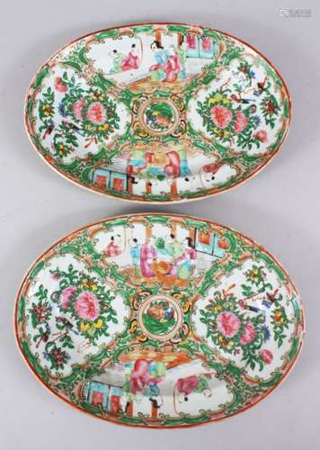 A PAIR OF 19TH CENTURY CHINESE CANTON FAMILLE ROSE OVAL PORCELAIN DISHES, both decorated with panels