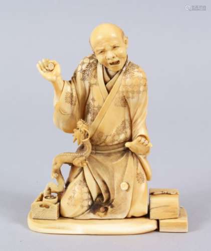 A JAPANESE MEIJI PERIOD CARVED IVORY OKIMONO OF AN ARHAT & DRAGON, the elder on his knees with his