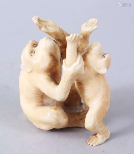 A JAPANESE MEIJI PERIOD CARVED OKIMONO GROUP OF MONKEYS, two seated monkeys play, 6.5cm high x 5cm