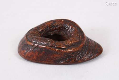 A GOOD JAPANESE MEIJI PERIOD CARVED WOOD OKIMONO OF A ROCK, with a central opening, 6cm wide.