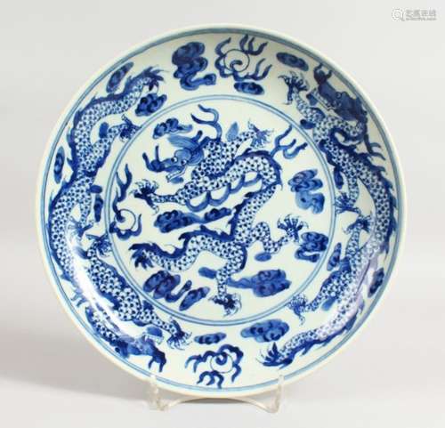 A CHINESE BLUE AND WHITE CIRCULAR DISH with dragon design. Six-character mark on base. 10.5ins