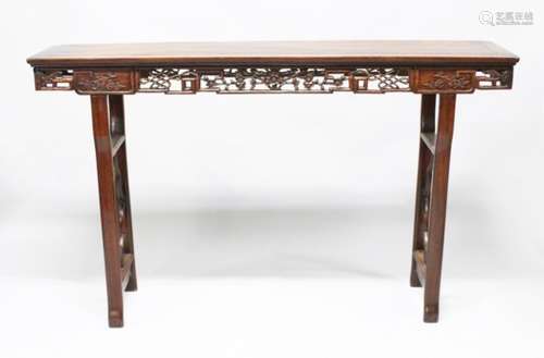 A LARGE 19TH CENTURY CHINESE HARDWOOD ALTER TABLE, the frieze carved to depict cherry blossom, stood