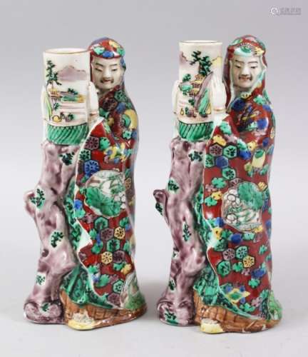 A PAIR OF JAPANESE MEIJI PERIOD KUTANI PORCELAIN CANDLESTICKS, depicting two immortals holding vases