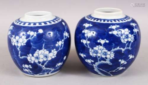 A NEAR PAIR OF EARLY 20TH CENTURY CHINESE BLUE & WHITE PORCELAIN PRUNUS JARS, the bases with