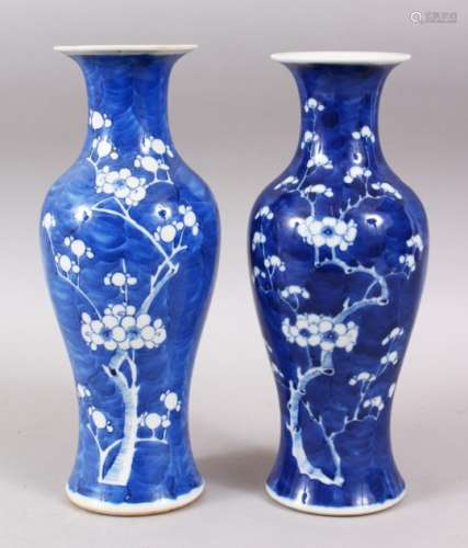 A NEAR PAIR OF 19TH CENTURY CHINESE BLUE & WHITIE PORCELAIN PRUNUS VASES, bases with double blue