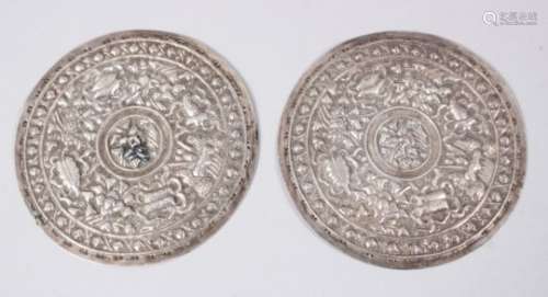 A PAIR OF 19TH CENTURY SINO TIBETAN SILVER PLAQUES FOR CEREMONY ROBES, the plaques with pressed