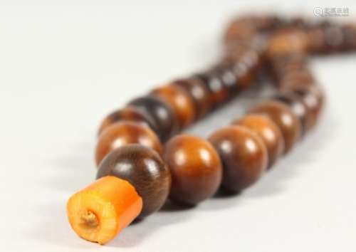 A 19TH CENTURY QING DYNASTY CHINESE RHINOCEROS HORN & AMBER ROSARY BEADS / NECKLACE, comprising of