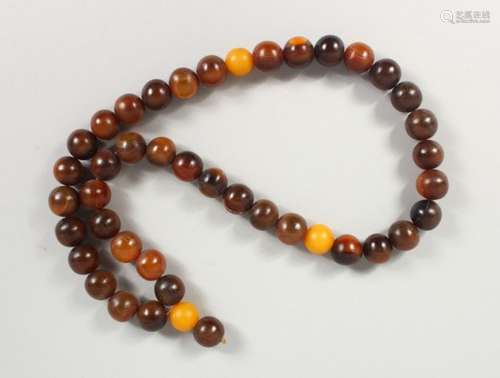 A 19TH CENTURY QING DYNASTY CHINESE RHINOCEROS HORN & AMBER ROSARY BEADS / NECKLACE, comprising of