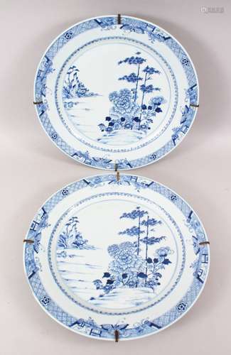 A LARGE PAIR OF 18TH CENTURY CHINESE QIANLONG BLUE & WHITE CHARGERS, decorated with scenes of native