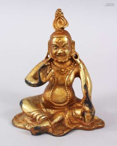 A 19TH CENTURY SINO TIBETAN GILDED BRONZE FIGURE OF A GOD / DEITY, in a seated position baring his