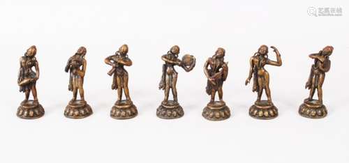 A MIXED LOT OF SEVEN 19TH / 20TH CENTURY INDIAN BRONZE MUSICIAN FIGURES, each holding a different