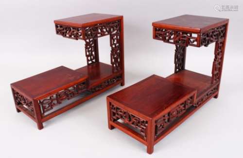 A PAIR OF LATE 19TH / 20TH CENTURY CHINESE CARVED HARDWOOD TWO TIER STANDS, with carved and