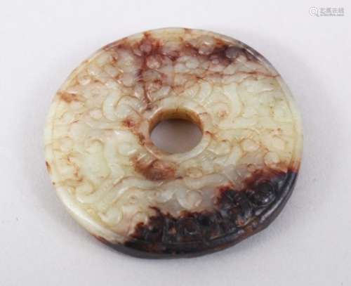 A GOOD 19TH / 20TH CENTURY CHINESE CARVED CELADON / RUSSET JADE BI DISK / PENDANT, carved in archaic