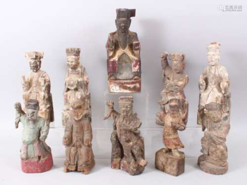 TEN 18TH / 19TH CENTURY CHINESE CARVED WOODEN FIGURES OF IMMORTALS, some with signs of lacquer,