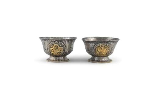 A PAIR OF TIBETAN SILVER AND GILT EMBELLISHED BUTTER BOWLS, 19th century, applied with four
