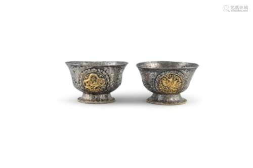 A PAIR OF TIBETAN SILVER AND GILT EMBELLISHED BUTTER BOWLS, 19th century, applied with four
