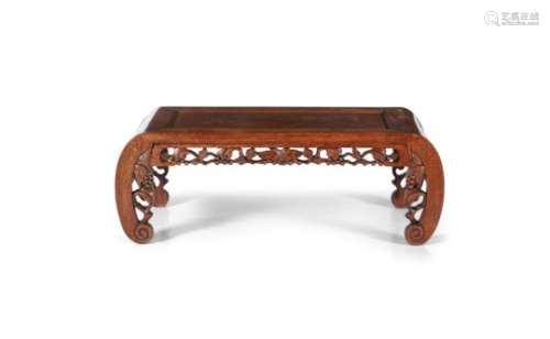 A CHINESE CARVED WOOD KANG TABLE, 20th century, of rectangular form with incurved legs and pierced