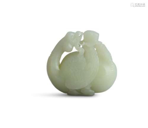 A CHINESE PALE JADE CARVING of mythical bird, modelled with returning glance and feeding on a flower