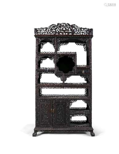 A CHINESE CARVED HARDWOOD DISPLAY CABINET, 19th Century, surmounted with pierced cornice, over an