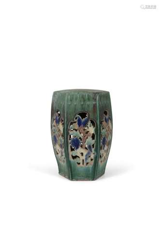 A CHINESE GREEN GLAZED POTTERY GARDEN SEAT, of hexagonal form with pierced panel sides, each