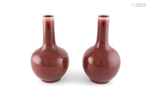 A PAIR OF 'SANG DE BOEUF' GLAZED VASES, c.1850, each with globular body and cylindrical neck, the