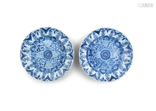 A PAIR OF CHINESE BLUE AND WHITE DISHES, Kangxi (1667 - 1722), each with central floral medallion