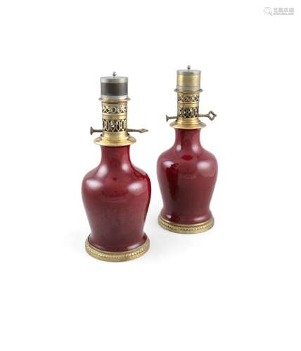 A PAIR OF RED MONOCHROME MALLET SHAPED VASES, 19th century, now with French ormolu bases and oil