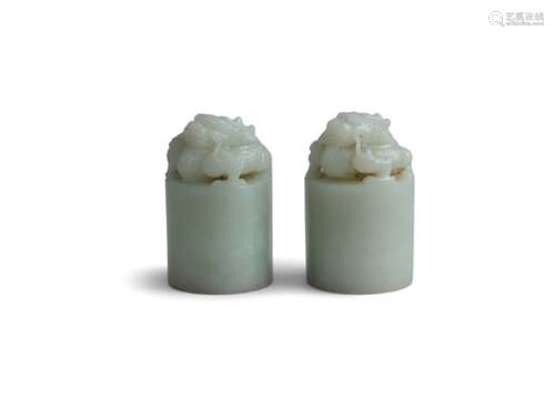 A PAIR CHINESE WHITE JADE DRAGON SEALS, 19TH CENTURYof cylinder form, surmounted with intricately