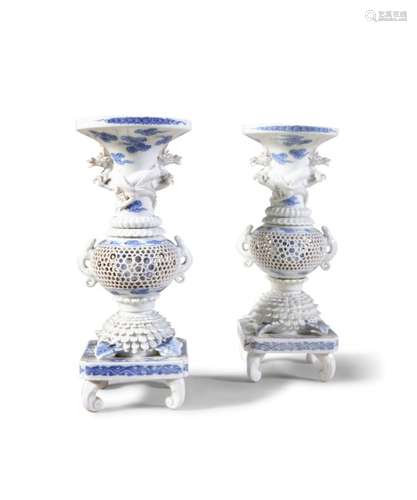 A PAIR OF JAPANESE HIRADO BLUE AND WHITE PORCELAIN VASES, 19th Century, with flared tops, moulded