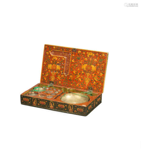 A Qajar lacquer box containing a set of portable merchant's weights and scales Persia, dated AH 1242/ AD 1826-27