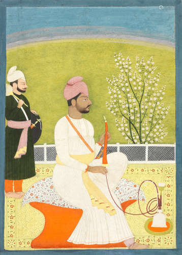Maharajah Bhup Singh of Guler (reg. 1790-1826) seated on a terrace smoking a hookah, an attendant standing by Guler, circa 1810