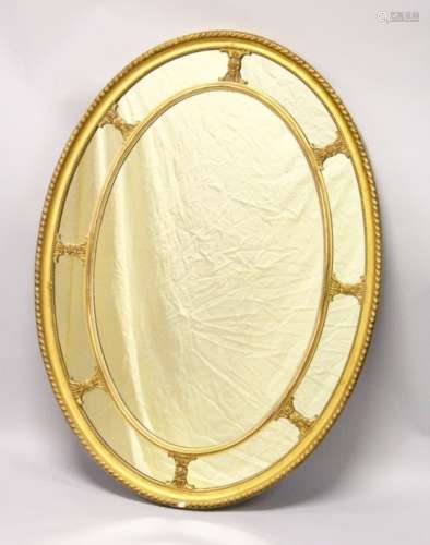 A LATE 19TH CENTURY ADAM REVIVAL GILT FRAMED OVAL WALL MIRROR, with gadroon carved frame. 3ft 8.5ins