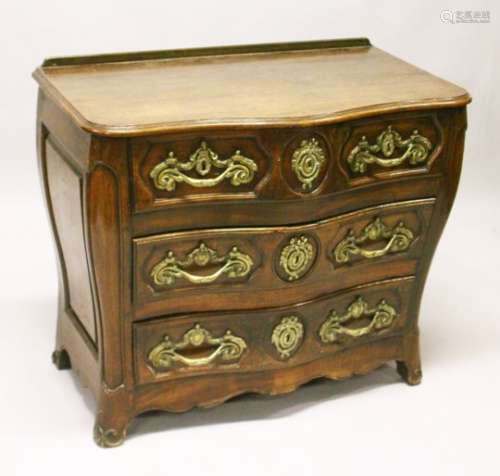 A LOUIS XV STYLE FRENCH OAK SERPENTINE FRONT COMMODE, comprising two short and two long drawers, all
