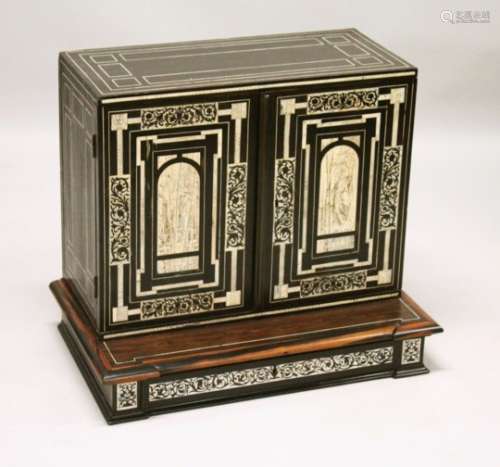 AN IVORY INLAID EBONY TABLE CABINET, the pair of doors inlaid with ached panels decorated with