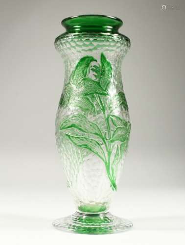 A FRENCH MOULDED AND CUT GLASS PEDESTAL VASE, with green floral decoration. 10.75ins high.
