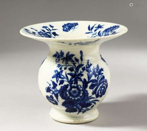 A RARE WORCESTER BLUE AND WHITE SPITTOON, decorated with scattered flowering plants and a butterfly,