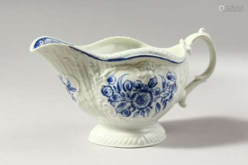 A WORCESTER BLUE AND WHITE SAUCEBOAT, crisply moulded with overlapping scales, painted with