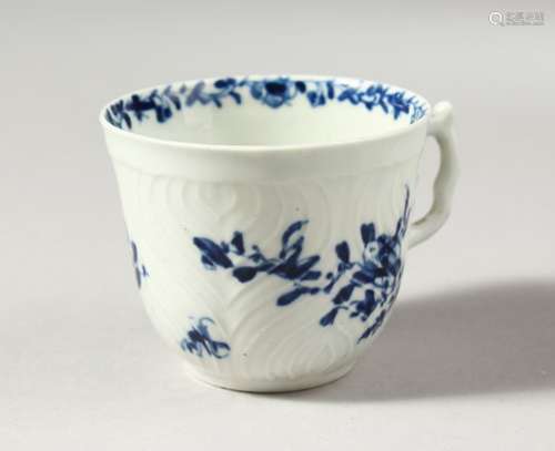 A WORCESTER BLUE AND WHITE HERRINGBONE MOULDED COFFEE CUP, painted with scattered flowers and a most