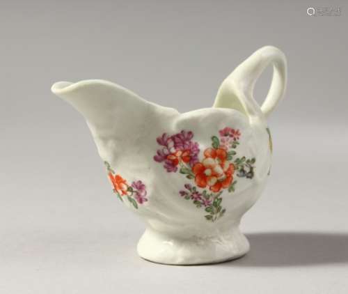 A LOWESTOFT SHELL MOULDED EWER, painted in colour with scattered flowers, no mark.